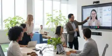 Professionals collaborating in a hybrid work environment with in-office and remote team members.